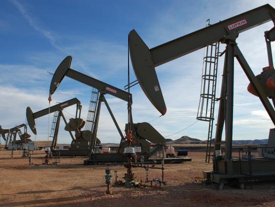 Oil drills in the Great Plains landscape with a big blue sky. 
